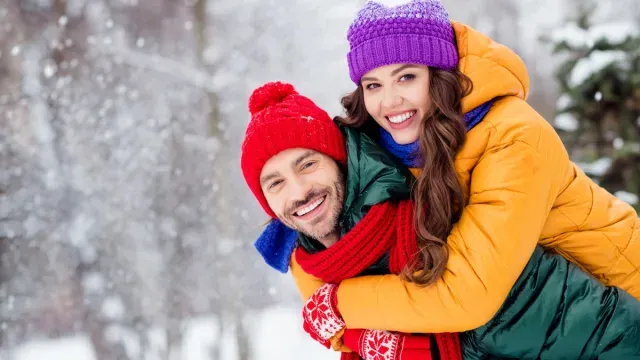 couple-wearing-down-jackets-in-snow